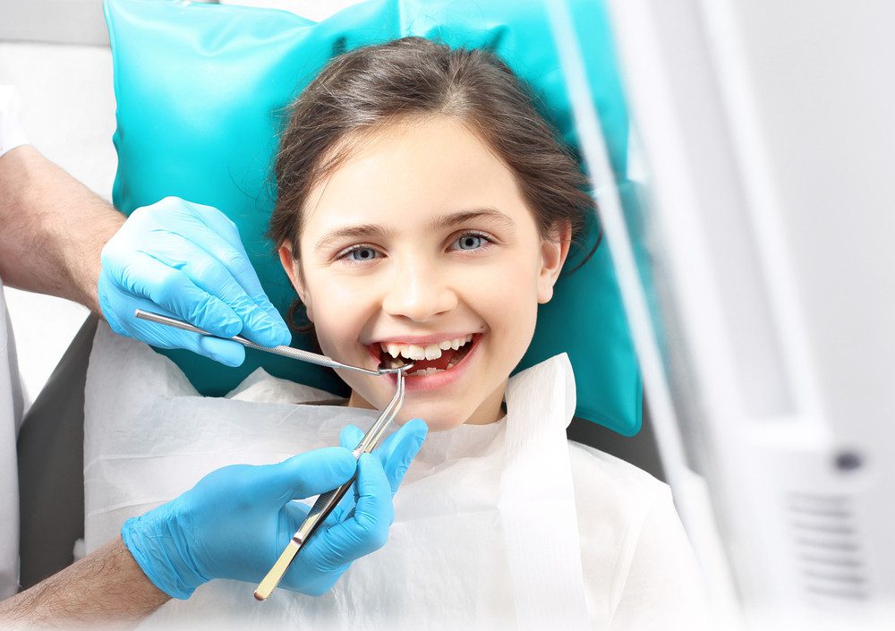 Child in the dental chair undergoing dental treatment