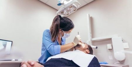 dentist doing teeth procedure on patient